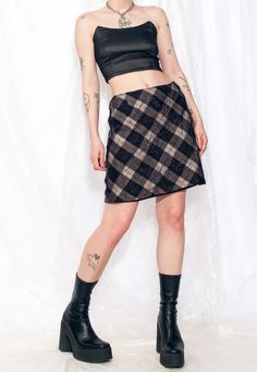 Y2K vintage plaid skirt with a twist. Made of wool and lined for maximum comfort, this mini skirt boasts a zip closure and an embroidered sheer upper layer. Plus, you'll be helping the planet while looking rad. Our model, Panna is 171 cm / 66.7" tall and she's a size S. Size: M / US 6 / UK 10 / IT 42 Other size info: Labelled size: D 38 Measurements:  waist: 74 cm / 28.9" length: 49 cm / 19.1" Fabric: wool 92%, polyester 4%, polyamide 4% Care: Dry clean only Rock Y2k, Checked Skirt, Preppy Plaid, Y2k Preppy, Skirt Y2k, Skirt Medium, Vintage Rock, Dark Academia Aesthetic, Academia Aesthetic