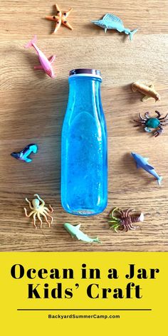 an ocean in a jar kids'craft with sea animals and sand on the table