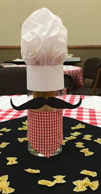 a paper hat and mustache on top of a cup with pasta noodles in it sitting on a table