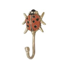 a ladybug brooch is hanging on a hook