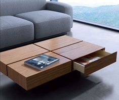 a coffee table with a book on it next to a couch