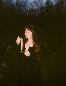 a woman holding a candle in her hands