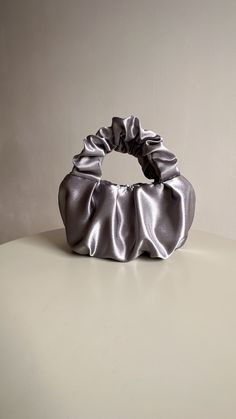 Silver evening bag made from smooth satin. Stylish designer woman bag is soft, but keeps its shape, closes with a magnetic button. Small satin bag is able to decorate not only official event, but also becomes a companion for every day. Perfect wedding bag. Scrunchies handbag consists of 3 layers: the outer material and the lining are satin, with a special seal between them so that the handbag keeps its shape. Small evening handbag can also be sewn from soft pleasant velvet. Material: Soft, pleas Elegant Gray Pouch Bag, Elegant Party Bag With Satin Finish, Chic Silver Pouch Evening Bag, Elegant Satin Finish Evening Bag For Party, Elegant Satin Evening Bag With Satin Finish, Elegant Solid Color Evening Bag, Chic Satin Clutch Evening Bag, Chic Satin Finish Evening Bag For Party, Elegant Gray Bag For Gift