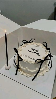 a birthday cake in a box with a candle