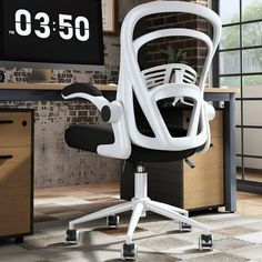 an office chair sitting in front of a desk with a clock on the wall behind it