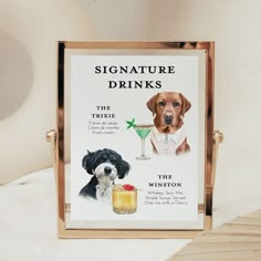 there is a sign that says signature drinks and two dogs next to each other on the table