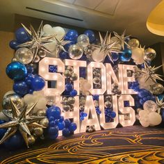 Blue, silver, and white Balloon garland covering Marquee Letters. Marquee Letters And Balloons, Prom Letters, Marquee Letters With Balloons, Light Up Words, Vegas Theme Party, Boys Gymnastics, Huge Balloons, Graduation Party Themes