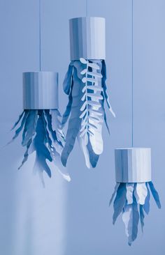 three blue and white paper hanging from strings