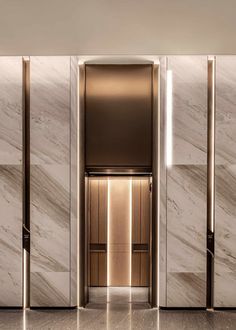 an elevator with marble walls and doors