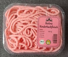 the pink yarn is wrapped in plastic