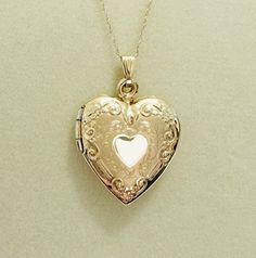 Vintage ornately engraved heart locket necklace! This gorgeous necklace features a 27.5x19.5" heart locket with enchanting engravings. Most of the locket is solid 10k yellow gold. On the inside, the rim of the locket is an alloy to increase durability; the rest of the locket is solid 10k yellow gold. The chain is solid 10k yellow gold and is 18.5 inches long. Together, the locket and chain weigh 2.8 grams. This divine locket pendant necklace is in excellent condition. It would make such a romantic gift! Engraved Locket, Locket Pendant Necklace, Heart Locket Necklace, Puffy Heart, Heart Locket, Romantic Gift, Locket Necklace, Gorgeous Necklaces, Chain Link Necklace