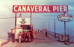 an old photo of some people standing in front of a sign that says canaverl pier