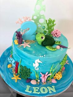 a blue cake decorated with sea animals and corals