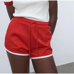 High-Waisted Shorts With Adjustable Elastic Waistband And Drawstring. Contrasting Trim Red Athleisure Bottoms With Elastic Waistband, Red Stretch Sporty Shorts, Red Bottoms With Elastic Waistband And Short Leg, Red Stretch Shorts With Elastic Waistband, Red Athleisure Shorts With Elastic Waistband, Red Stretch Casual Bottoms, Red Athleisure Bottoms With Short Legs, Red Athleisure Shorts For Summer, Red Athleisure Shorts For Spring