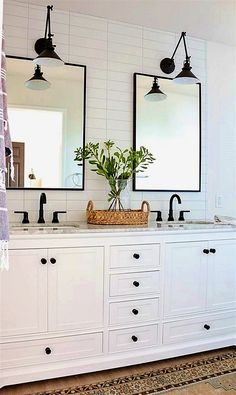 a bathroom with double sinks and two mirrors on the wall next to eachother