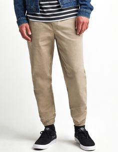 RSQ Twill Jogger Pants. Cotton twill 4-way stretch pants. Elastic drawstring waist. Slant hand pockets. Small right side zip pocket. Back right welt button pocket. Tapered jogger fit. Elastic cuffs. Approx. outseam: 40.5". 97% cotton/3% spandex. Machine wash. Imported.Size + FitShort: 27" – 30" inseam Regular: 29" – 32" inseam Tall: 31" – 34" inseam Casual Cotton Bottoms For Fall, Spring Casual Pants For Elevated Casual Occasions, Casual Fall Overalls, Spring Casual Pants For Elevated Occasion, Casual Summer Bottoms For Elevated Casual Look, Summer Casual Bottoms For Elevated Casual Look, Casual Tapered Leg Pants, Casual Tapered Leg Bottoms For Fall, Casual Bottoms With Elastic Waistband And Tapered Leg