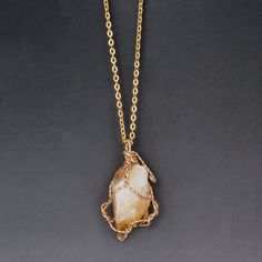 Spiritual Quartz Jewelry With Large Stone, Spiritual Gold Gemstone Crystals, Amber Jewelry With Large Stone As Gift, Spiritual Amber Jewelry With Raw Stone, Raw Stone Agate Jewelry Gift, Amber Necklace With Large Stone As Gift, Amber Necklace With Large Stone For Gift, Gold Crystal Necklaces With Large Stone For Gifts, Gold Agate Spiritual Crystal Necklace