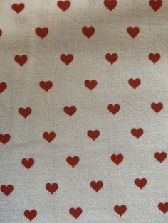 red hearts on white fabric with small dots