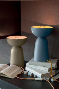 a table topped with books and a lamp