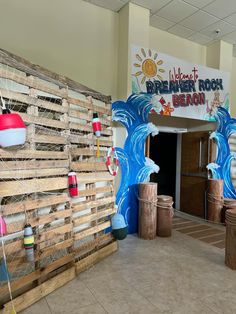 the entrance to an indoor children's play area with wooden crates and buckets