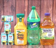 several different types of juices and condiments on a wooden table