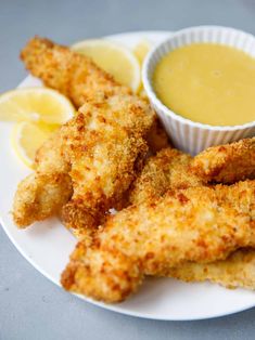 fried fish sticks and dipping sauce on a white plate