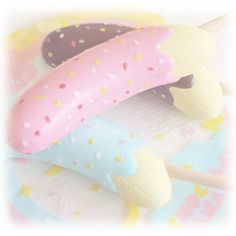 three donuts and two ice cream pops on a stick