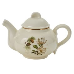 a white tea pot with flowers painted on the side and gold trimming around it