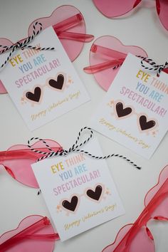 three valentine's day cards with hearts on them and some streamers in the background