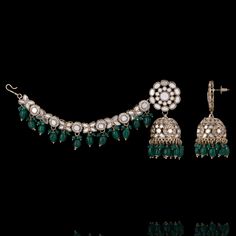 Add a touch of regal splendor to your look with our must-have Vishali Set! A perfect blend of elegance and traditional charm, this earring and maang teekah set is a true testament to the craftsmanship of our skilled artisans. Studded with mirror stones and pearls, this set is designed to complement any ensemble and make a statement wherever you go. Approximate earrings length is 3". Gold-plated on high-quality brass as base metal. Vishali Set (Emerald) is in-stock & ready-to-ship. *Please Note: Traditional Jewelry Sets With Matching Earrings For Diwali, Traditional Diwali Jewelry Sets With Matching Earrings, Elegant Ceremonial Jhumkas With Stone Work, Ceremonial Chandbali Sets With Latkans, Bollywood Ceremonial Jewelry With Matching Earrings, Bollywood Style Ceremonial Jewelry With Matching Earrings, Traditional Jewelry With Matching Earrings For Eid, Traditional Hand Set Bridal Earrings For Eid, Elegant Ceremonial Jhumkas For Eid