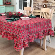 the table is covered with red and green plaid cloths as well as two wooden chairs