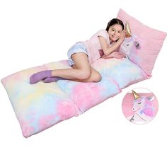 a woman laying on top of a unicorn pillow