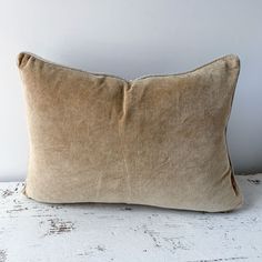 a brown pillow sitting on top of a white table