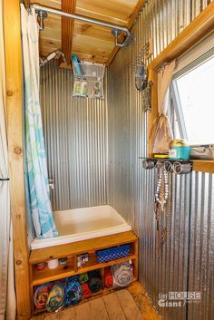 the inside of a small bathroom with a sink and shower