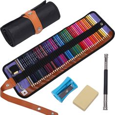 an assortment of colored pencils and sharpener in a case with leather strap next to it