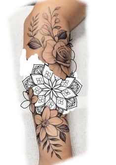 a woman's arm with flowers and leaves on it