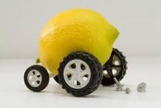 a toy truck made out of lemons and wheels