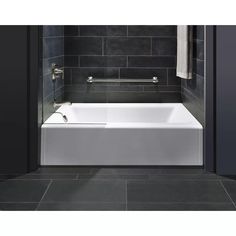 a white bath tub sitting inside of a bathroom