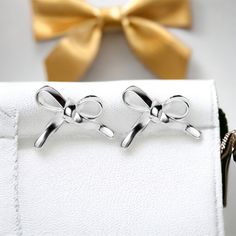 Introducing our Vermeil 18k gold plated 925 sterling silver elegant bow earrings. Crafted with meticulous attention to detail, these earrings features exquisite hand crafted enamel plated mushrooms. While corky by design the hand made earrings can also add a touch of sophistication to any outfit.    Made from high-quality 925 sterling silver, this piece is then expertly plated with a layer of 18k gold, creating a luxurious and durable finish.    The contemporary design of these earrings makes it a versatile accessory that can be worn for both casual and formal occasions.   With its sleek and modern aesthetic, these earrings are sure to become a timeless addition to your jewelry collection. 16 mm long, 11.5 mm deep, and 6 mm wide these make a very danity piece of jewelry. Care Tips for your Gift Earrings With Plating, Classic Silver Earrings As Gift, Classic Silver Earrings For Gift, White Bow Earrings For Anniversary, Classic Bow Earrings For Anniversary, Elegant White Gold Earrings With Bow, White Gold Bow Earrings For Formal Occasions, Butterfly Knot Drop Earrings For Gift, Silver Bow Jewelry As A Gift