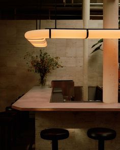 a table with stools and lights hanging from it