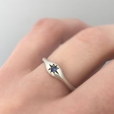 Signet ring with a hand engraved star and bead set blue sapphire. Wear it as a signet ring, or it could be a non-traditional engagement ring, one that's low profile and easy to wear. Choose sterling silver or 14k gold with a blue sapphire. DETAILS - 2.2 mm blue sapphires vary in color from light to dark blue. Add a note if you have a preference on tone. - Choose 14k rose, yellow or palladium white gold or sterling silver - nickel free - 14k palladium white gold is a medium grey color and is not Celestial Sapphire Birthstone Ring As Gift, Celestial Sterling Silver Signet Ring For Anniversary, Star-shaped Birthstone Promise Ring, Sapphire Signet Ring Fine Jewelry For Gift, Celestial Star-shaped Signet Ring, Celestial Star Shaped Signet Promise Ring, Celestial Star-shaped Signet Promise Ring, Sterling Silver Star Shaped Signet Ring For Anniversary, Celestial Sapphire Birthstone Ring For Anniversary