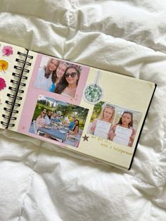 an open notebook with photos on it sitting on top of a white bed sheet covered in flowers