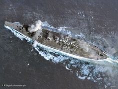 an aerial view of a battleship in the ocean