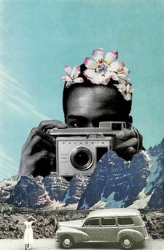 a person taking a photo with a camera in front of mountains and a car on the road