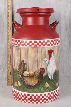 a red vase with roosters and chickens painted on it