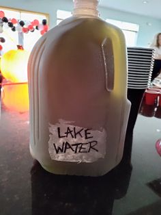 a plastic bottle with the words lake water written on it sitting on a counter top