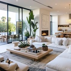 a living room filled with lots of furniture and a fire place in the middle of it