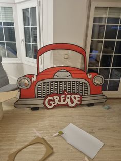 an old red truck with the word grease painted on it