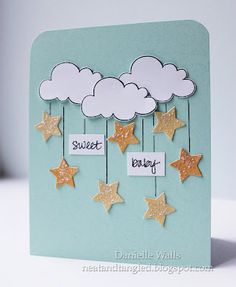 a card with stars and clouds hanging from it's sides that says sweet baby