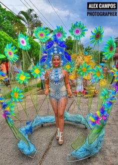 a woman standing in front of some fake flowers